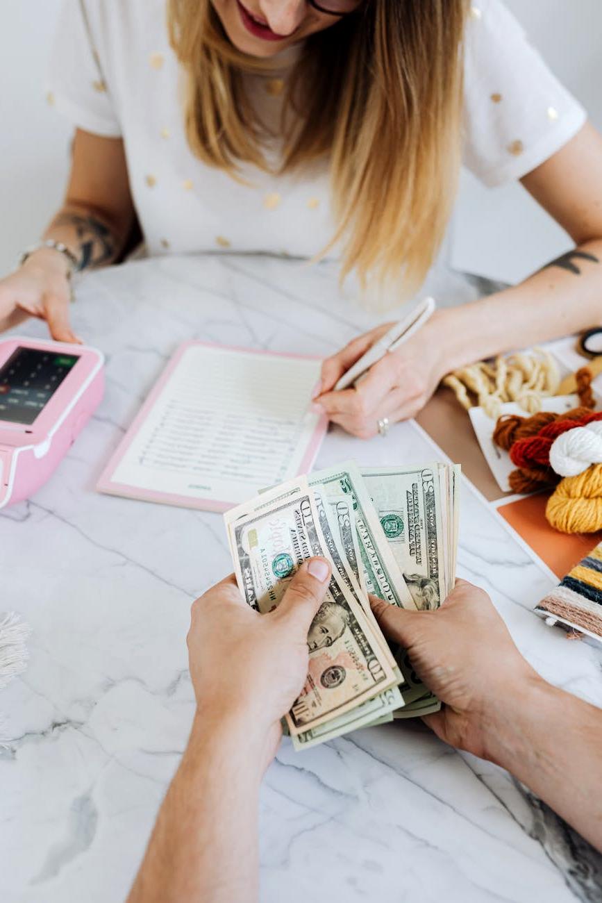 Traveler planning expenses with a laptop and notes