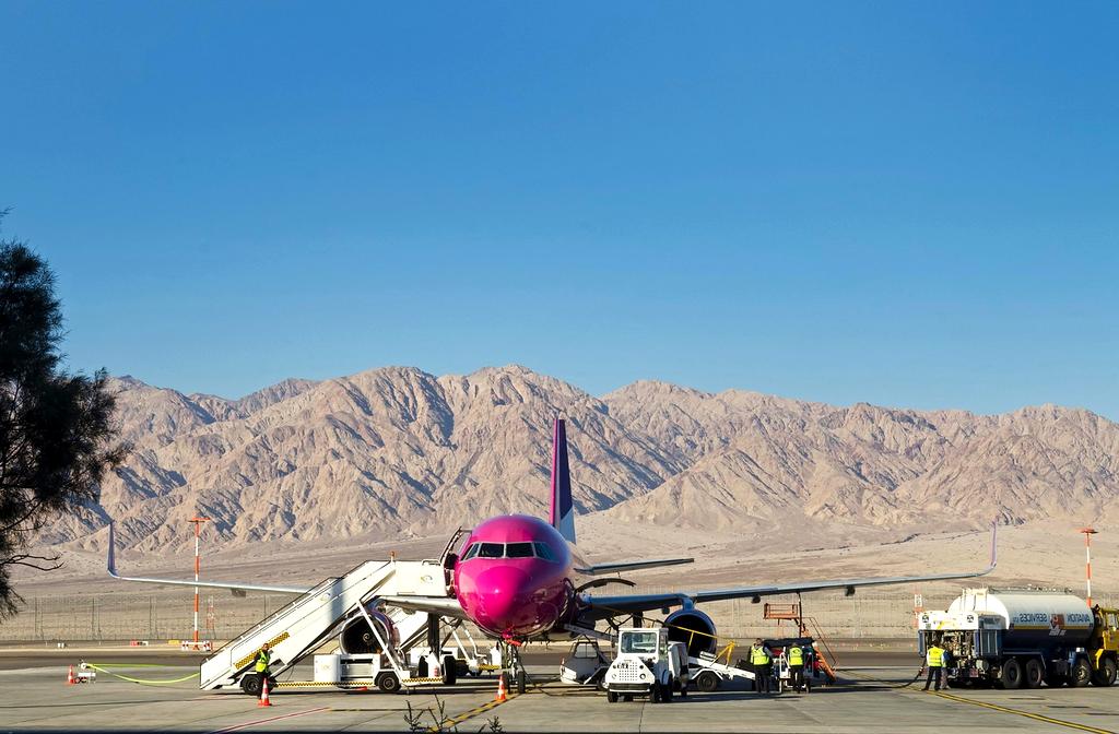 Traveler planning budget with notebook and laptop