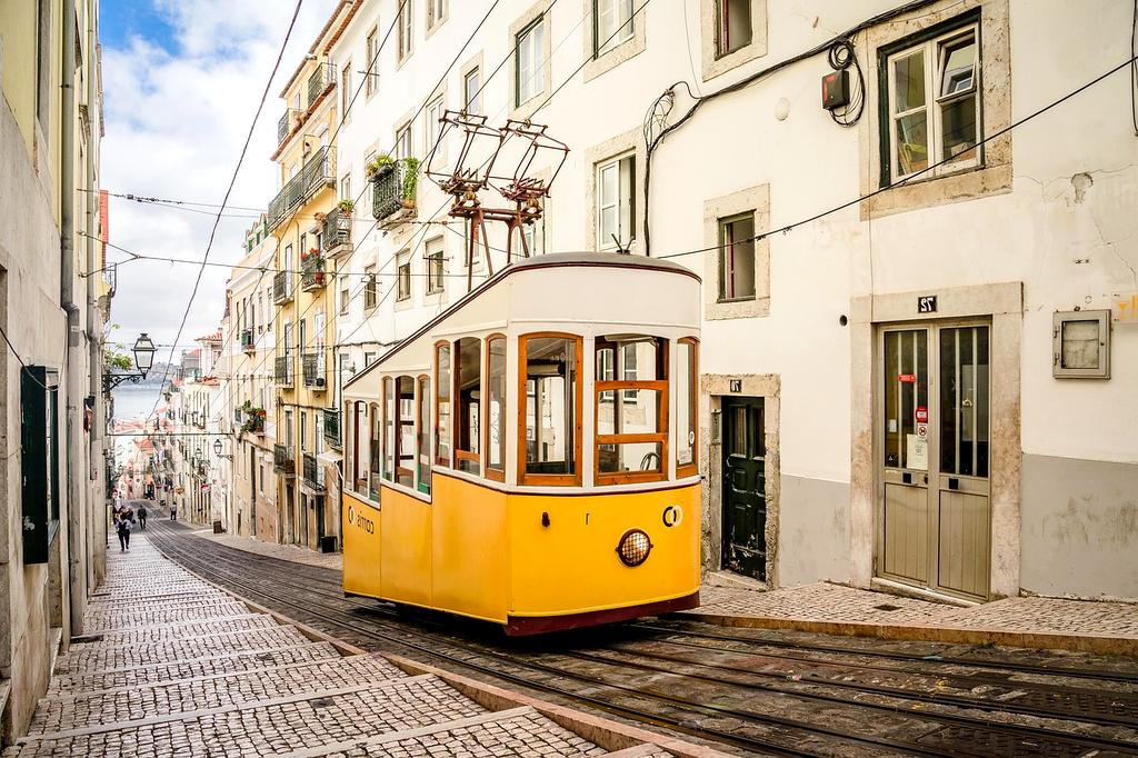 Colorful traditional trams on steep Lisbon streets